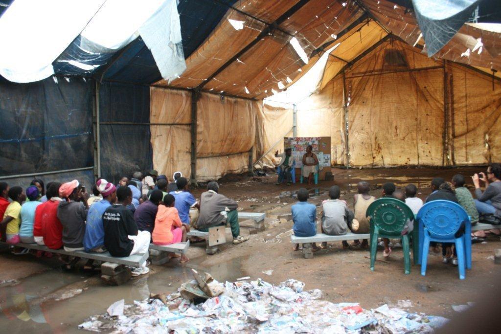 Mazwi community captured attending the puppetry show in a soaked tent hall. Pic by Chrispen Tabvura